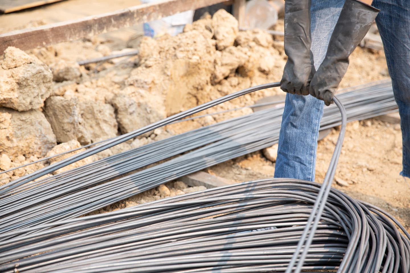 Coils of high-tensile steel strand being handled on a UAE construction site